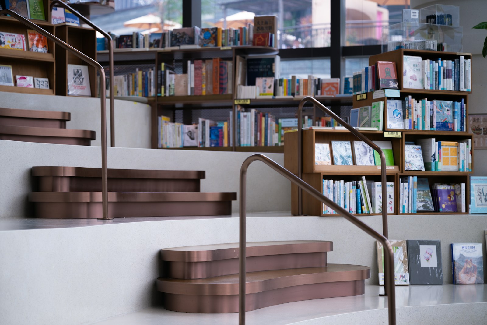 a set of stairs leading up to a bookshelf filled with books