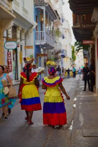 a couple of women walking down a street next to each other